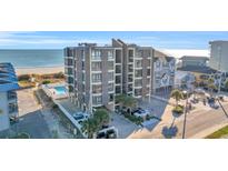 Coastal condo building featuring a pool, multiple balconies, and nearby beach access at 5910 N Ocean Blvd. # 504, North Myrtle Beach, SC 29582