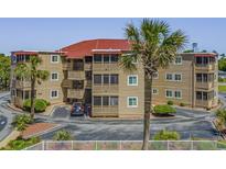 Coastal condo building featuring multiple balconies and lush landscaping at 609 Hillside Dr. S # D-17, North Myrtle Beach, SC 29582