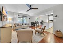 Inviting living room features a contemporary design, comfortable seating, and sliding glass doors to the balcony at 10301 North Kings Hwy. # 21-4, Myrtle Beach, SC 29572