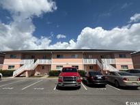 Well-maintained two-story condo building with ample parking and exterior staircases to upper units at 1101 2Nd Ave. N # 403, Surfside Beach, SC 29575