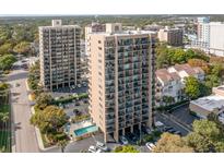 A beautiful exterior view of the high-rise building with balconies and a pool surrounded by parking at 210 75Th Ave N # 4114, Myrtle Beach, SC 29572