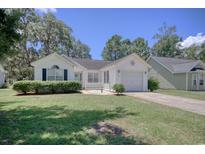 Charming single-story home featuring a well-manicured lawn and inviting curb appeal on a sunny day at 23 Robert Conway Ct., Georgetown, SC 29440
