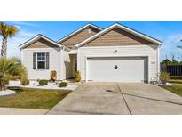 Charming single-story home with a two-car garage and well-maintained landscaping at 2804 Ophelia Way, Myrtle Beach, SC 29577