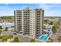 Beautiful condominium building with many balconies, a swimming pool, and lovely landscaping at 400 20Th Ave. N # 606, Myrtle Beach, SC 29577