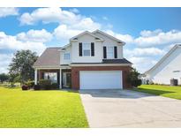 Charming two-story home with a well-manicured lawn, brick accents, and a two-car garage at 417 Pennington Loop, Myrtle Beach, SC 29588