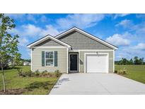 Charming single-story home with a well-manicured lawn and attached one car garage at 560 Strawberry Field Way, Galivants Ferry, SC 29544