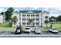 Inviting condominium building featuring multiple levels and well-maintained landscaping with ample parking at 697 Tupelo Ln. # 24G, Longs, SC 29568