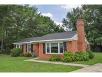 Charming brick home with a well-maintained lawn and mature trees at 728 Tarpon Ct., Myrtle Beach, SC 29579