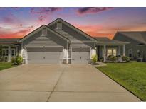 Charming single-story home boasting a well-manicured lawn and a convenient two-car garage with a beautiful sunset in the background at 860 Brant St., Myrtle Beach, SC 29579