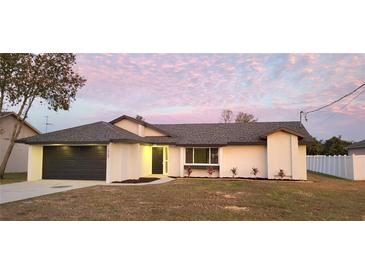 Charming single story home featuring a modern gray roof, fresh landscaping, and a two-car garage at 2469 Courtland Blvd, Deltona, FL 32738