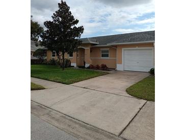 Charming single-story home featuring a well-manicured lawn, attached garage, and inviting curb appeal at 3110 Port Royal Dr, Orlando, FL 32827