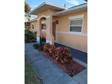 Charming home entrance with colorful landscaping and covered entry way at 3110 Port Royal Dr, Orlando, FL 32827