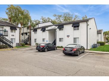 Apartment building exterior with parking and landscaping at 4213 S Semoran Blvd # 9, Orlando, FL 32822