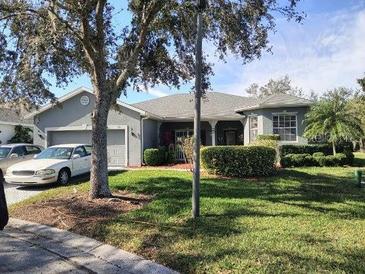 Single-story home with attached garage and well-manicured lawn at 251 Rock Springs Dr, Poinciana, FL 34759