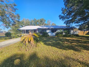 Single-story house with a large front yard and mature trees at 4751 Meadow Dr, Saint Cloud, FL 34772