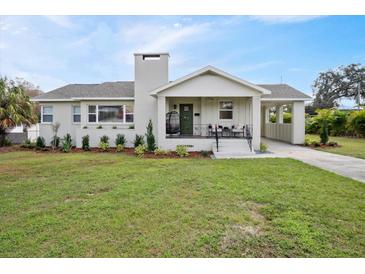 Charming single-story home with landscaped front yard, covered porch, and attached carport at 2814 Coventry Ave, Lakeland, FL 33803