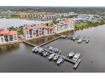 Aerial view of waterfront community with boat slips and resort-style building at 612 Marina Point Dr # 6120, Daytona Beach, FL 32114