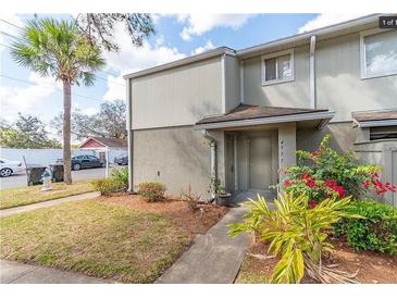 Inviting condo exterior with a well-maintained lawn and walkway at 4537 Ring Neck Rd # C, Orlando, FL 32808