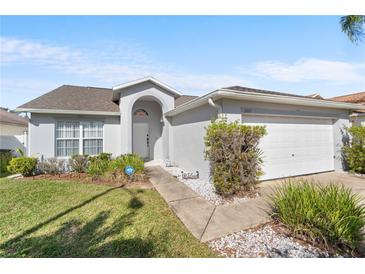 One-story home with a two-car garage and well-maintained lawn at 1010 Clear Creek Cir, Clermont, FL 34714