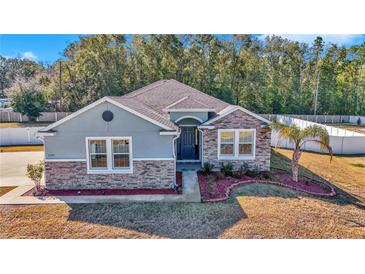 One-story home with stone accents and a two-car garage at 1320 Se 63Rd Court Rd, Ocala, FL 34472