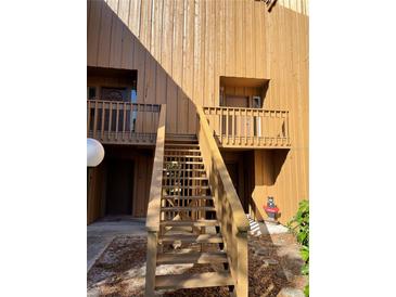 Condo building with stairs and wood siding at 255 Crown Oaks Way, Longwood, FL 32779