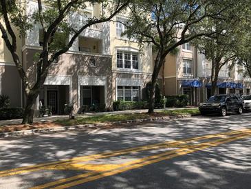 Exterior of a charming condo building with lush landscaping and ample parking at 705 Celebration Ave # 705, Celebration, FL 34747