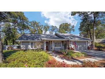 Charming single-story home with manicured landscaping, walkway, and American flag at 4503 Se 14Th St, Ocala, FL 34471