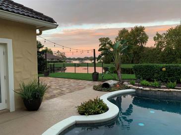 Stunning backyard oasis with pool, patio, and lake views at 889 Brantley Dr, Longwood, FL 32779