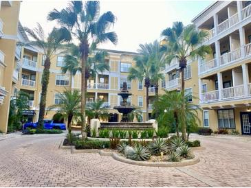 Beautiful courtyard with a central water fountain surrounded by lush landscaping and multi-story buildings at 860 N Orange Ave # 258, Orlando, FL 32801