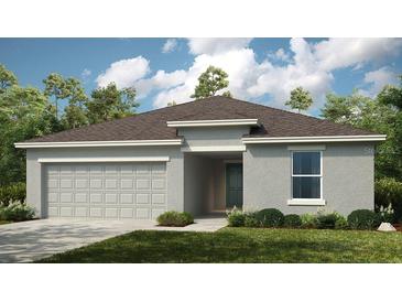 Charming single-story home with a two-car garage, lush lawn, and neutral-toned exterior at 2026 Babbling Brook Blvd, Auburndale, FL 33823