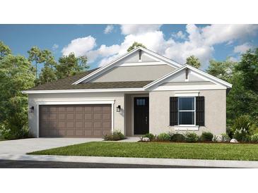 Charming single-story home with a two-car garage, neat landscaping, and a welcoming front door at 2136 Babbling Brook Blvd, Auburndale, FL 33823