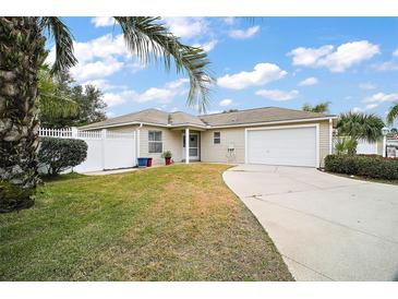Charming single-story home featuring a well-manicured lawn and an attached two-car garage at 2378 Ridgeway Ct, The Villages, FL 32162