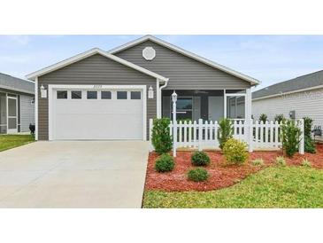 Charming single-story home featuring a two-car garage and well-manicured front yard at 3575 Cochran St, The Villages, FL 32163