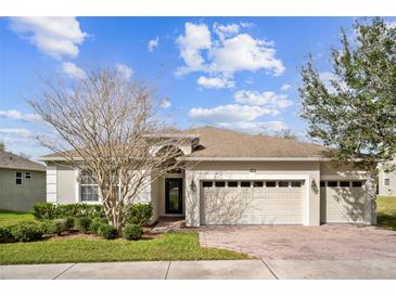 Charming single-Gathering home featuring a brick driveway and a well-maintained lawn at 1086 Harmony Ln, Clermont, FL 34711
