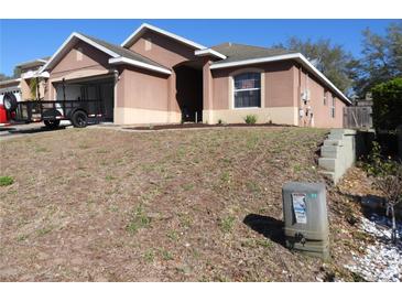Charming single-story home featuring a well-manicured front yard and an attached garage at 30126 Sandbunker Ln, Sorrento, FL 32776