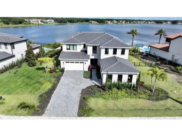 Stunning two-story home with meticulously landscaped yard and a driveway leading to a spacious two-car garage at 16832 Bolsena Dr, Bella Collina, FL 34756