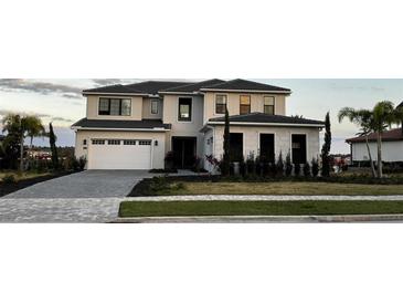Beautiful two-story home with a two-car garage, landscaped front yard, and a well-maintained lawn at 16832 Bolsena Dr, Bella Collina, FL 34756