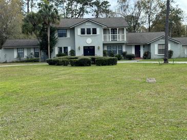 Charming two-story home with a well-manicured lawn and lush landscaping at 1818 Lago Ct, St Cloud, FL 34769