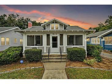 Charming single-story home featuring a cozy porch, well-maintained landscaping, and a welcoming facade at sunset at 501 Washington Ave, Eustis, FL 32726