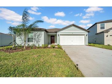 Inviting single-story home with well-manicured lawn and a two car garage at 744 Osprey Roost Dr, Lakeland, FL 33801
