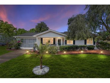 Charming single-story home with a well-manicured lawn and screened garage at 11540 Sw 84Th Avenue Rd, Ocala, FL 34481