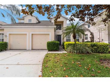 Charming two-story home with a two-car garage and lush, well-maintained landscaping at 2710 Manesty Ln, Kissimmee, FL 34747