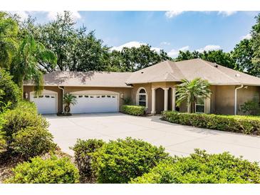 Stunning home with mature landscaping, a wide driveway, and a three-car garage that enhances its curb appeal at 17358 Hwy 27, Clermont, FL 34715