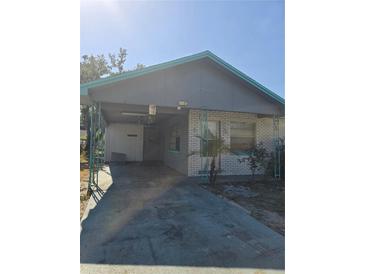 View of the home's front with an attached carport at 605 Maggie Cir, Winter Haven, FL 33880