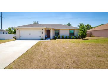 Charming single-story home with a well-manicured lawn, inviting entrance, and attached two-car garage at 13257 Sw 29Th Cir, Ocala, FL 34473