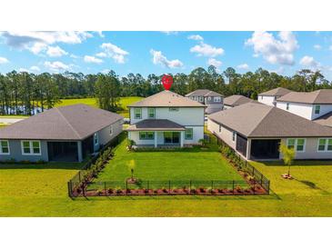Beautiful backyard with a well-maintained lawn and black metal fence at 3153 Legends Preserve Dr, Daytona Beach, FL 32124