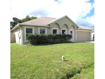 Charming single-story home with a well-maintained lawn and attached two-car garage at 1118 Perpignan Ct, Kissimmee, FL 34759