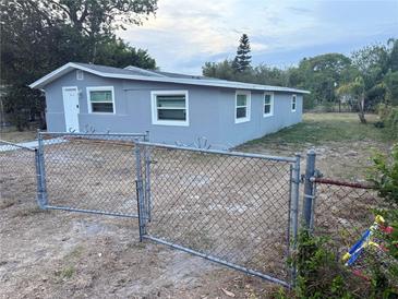 Charming single-story home with a fenced yard and well-maintained exterior paint, ready for new owners at 311 James Ave, Auburndale, FL 33823