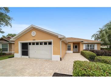 Charming single-story home boasts a paved driveway, attached garage, and manicured landscaping at 8166 Sw 80Th Ter, Ocala, FL 34476