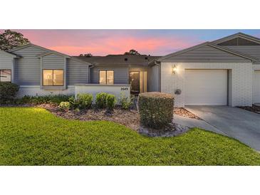 Charming single-story home featuring a well-manicured lawn and inviting front entrance at 2049 Se 37Th Court Cir, Ocala, FL 34471